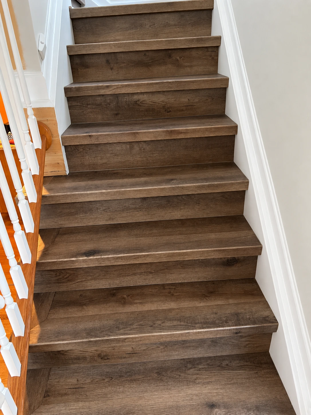 Completed custom vinyl stair treads coordinated with luxury vinyl plank flooring